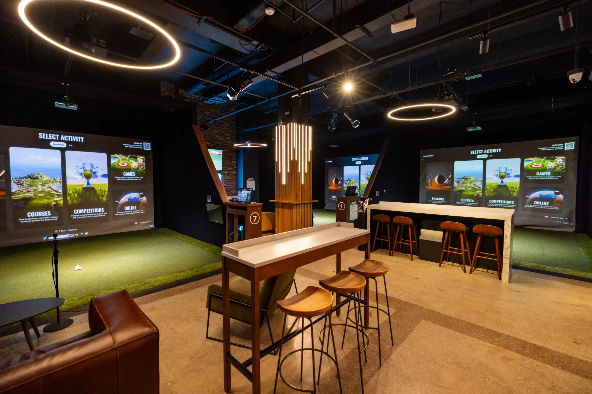 Five Iron Golf simulator bays with lounge seating
